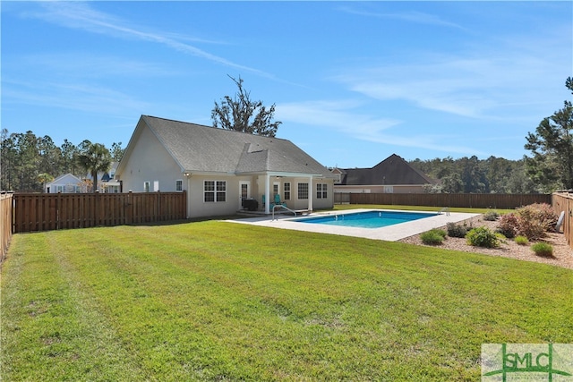 view of pool with a patio and a yard