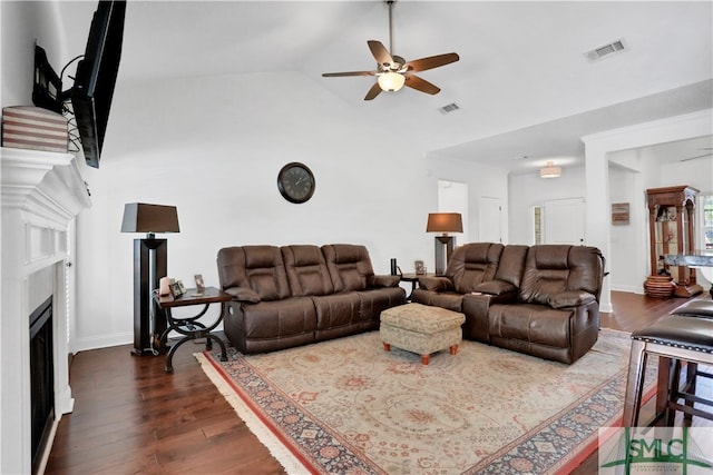 living room featuring vaulted ceiling, ceiling fan, and dark hardwood / wood-style flooring