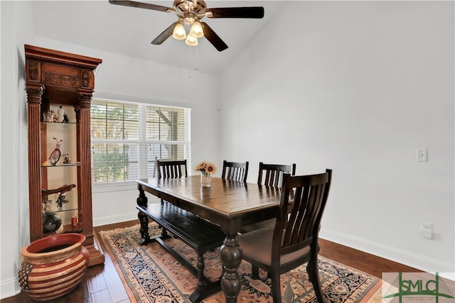 dining room featuring ceiling fan, wood-type flooring, and lofted ceiling