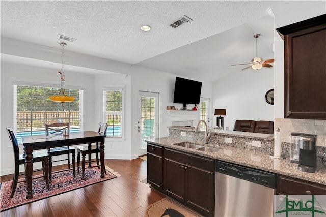 kitchen featuring sink, light stone countertops, dark brown cabinets, dark wood-type flooring, and dishwasher