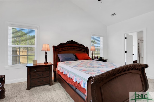 bedroom with light carpet and vaulted ceiling