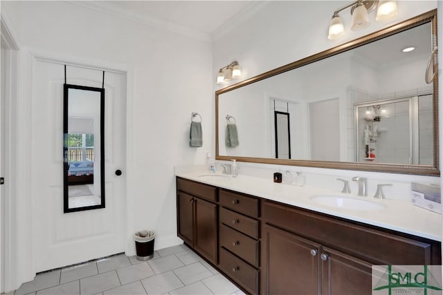 bathroom with tile patterned flooring, vanity, crown molding, and a shower with door