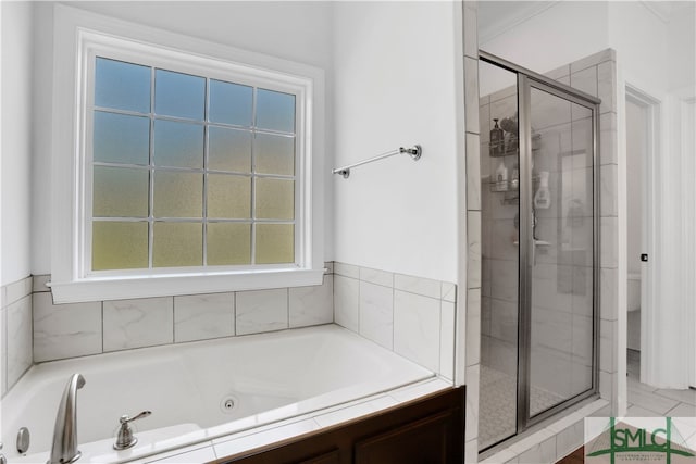 bathroom featuring shower with separate bathtub