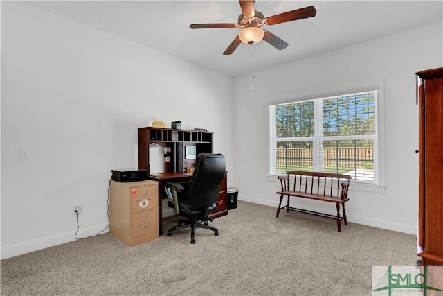 carpeted office space featuring ceiling fan