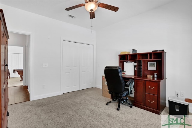 office area featuring light carpet and ceiling fan