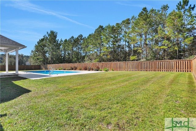 view of yard featuring a fenced in pool and a patio