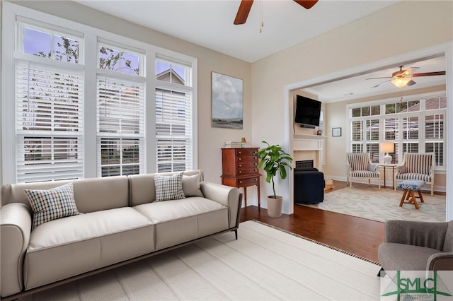 living room with hardwood / wood-style floors, plenty of natural light, and ceiling fan