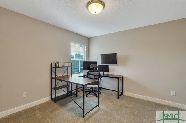 office with carpet flooring and a textured ceiling