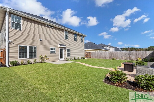 rear view of house with a lawn and a patio area