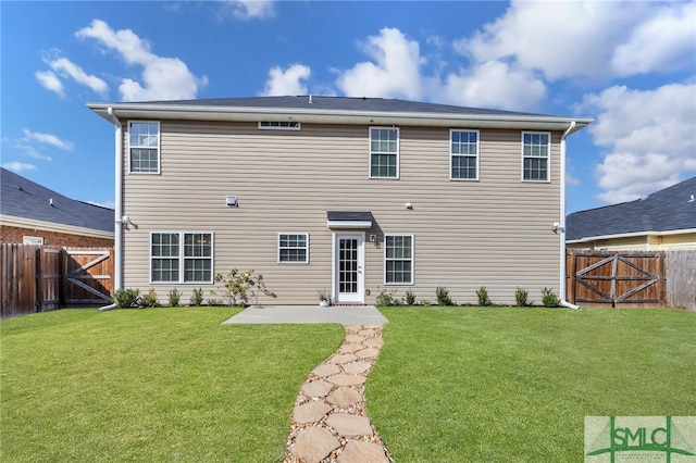 back of property featuring a lawn and a patio