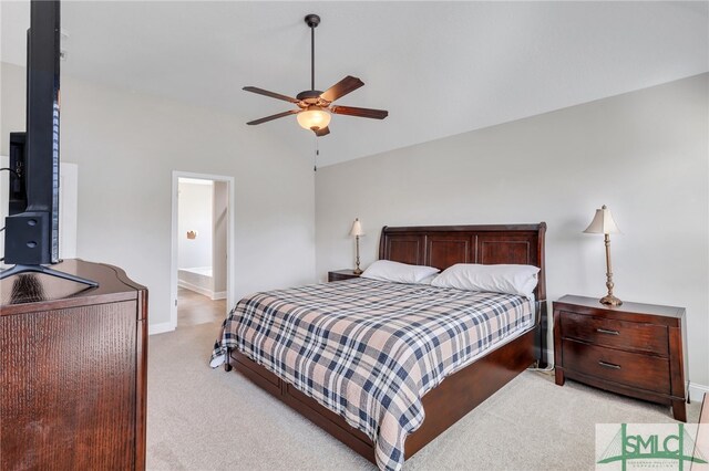 carpeted bedroom with connected bathroom, lofted ceiling, and ceiling fan