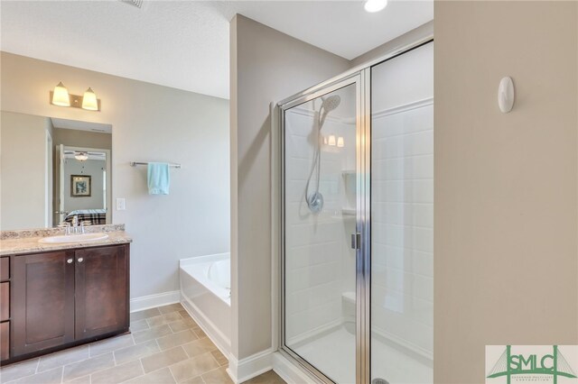 bathroom with independent shower and bath, vanity, and tile patterned floors