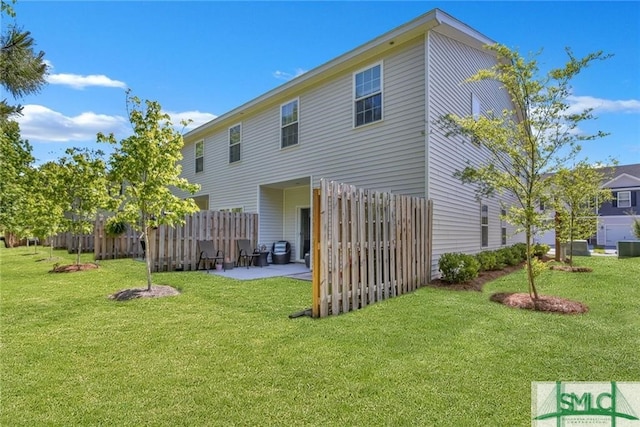 back of house featuring a yard and a patio area