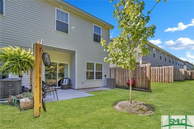 back of property featuring central AC, a lawn, and a patio