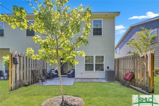 back of house featuring a yard, cooling unit, and a patio area