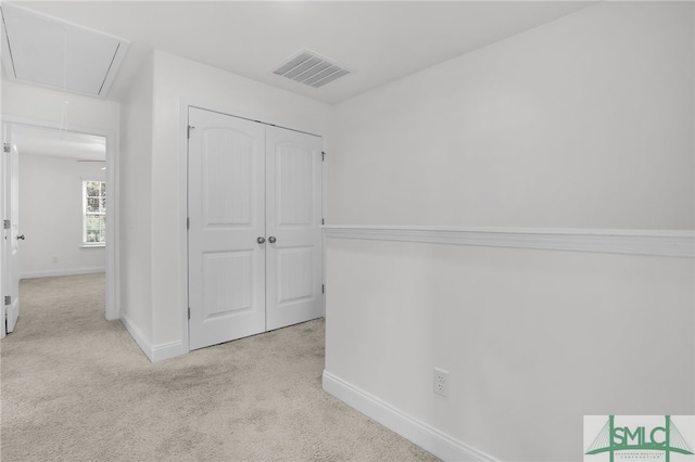 hallway featuring light colored carpet