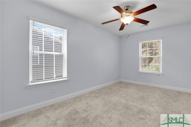 empty room with ceiling fan and carpet flooring