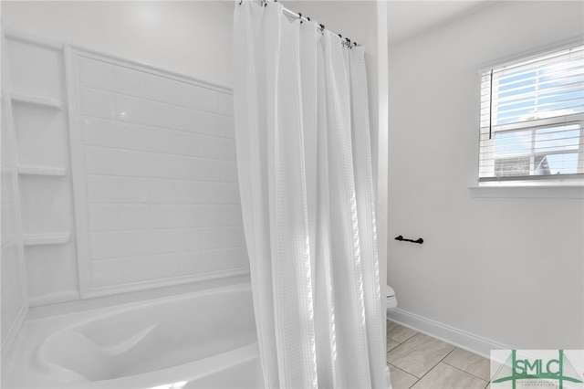 bathroom with toilet, shower / tub combo with curtain, and tile patterned floors