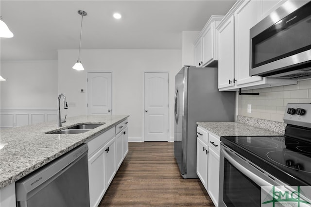 kitchen featuring white cabinets, sink, pendant lighting, dark hardwood / wood-style floors, and stainless steel appliances