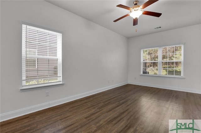 unfurnished room with ceiling fan and dark wood-type flooring