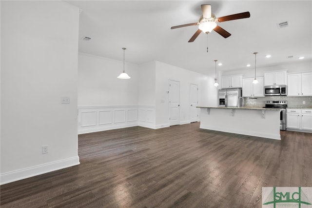 unfurnished living room featuring ceiling fan, dark hardwood / wood-style flooring, and sink