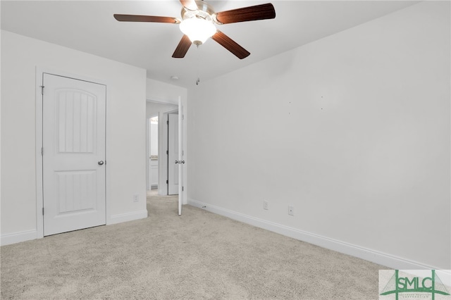 unfurnished bedroom featuring light colored carpet and ceiling fan