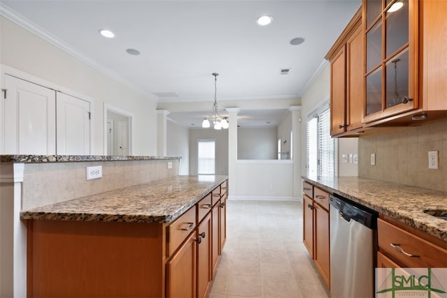 kitchen featuring stainless steel dishwasher, light stone countertops, pendant lighting, and backsplash