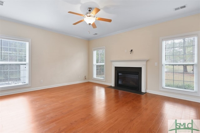 unfurnished living room with ceiling fan, crown molding, and light hardwood / wood-style flooring