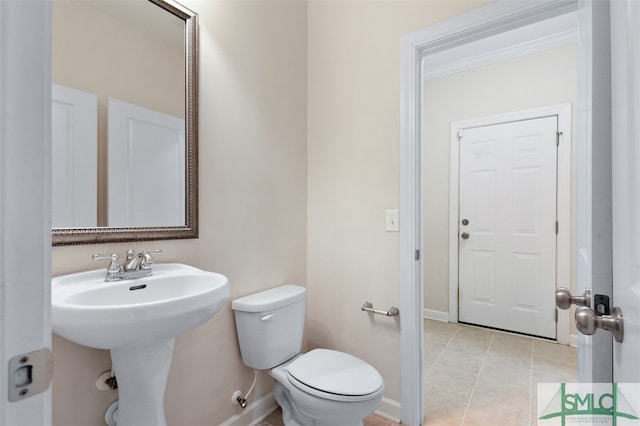 bathroom with tile patterned floors and toilet