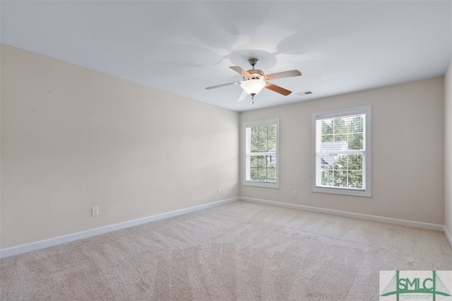 spare room featuring ceiling fan and light carpet