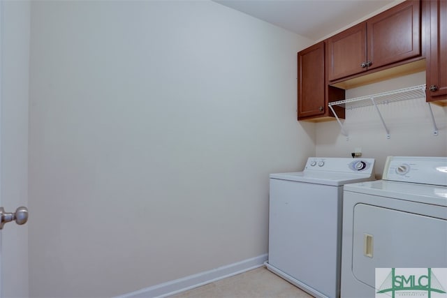 laundry area featuring cabinets and washing machine and clothes dryer