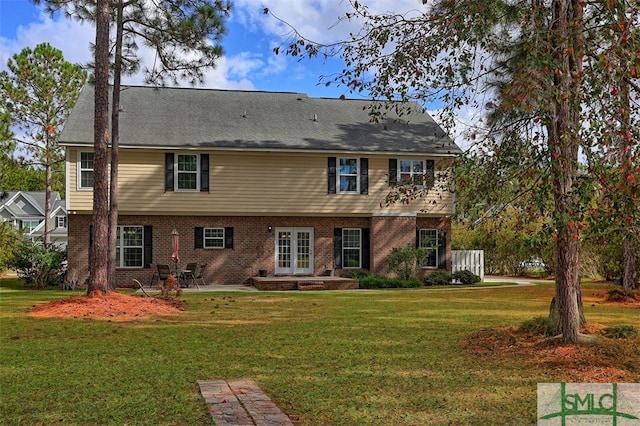 back of house with a yard and french doors