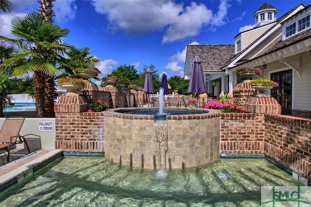 view of patio featuring pool water feature