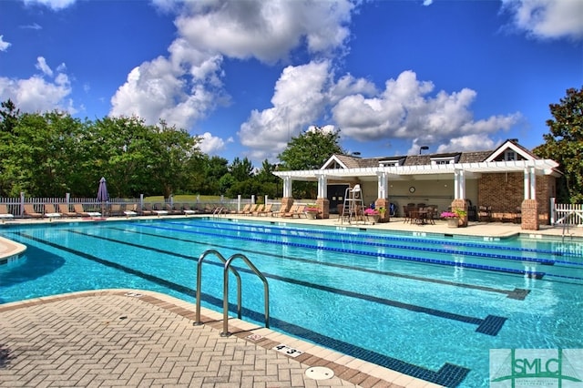 view of swimming pool featuring a patio and a pergola