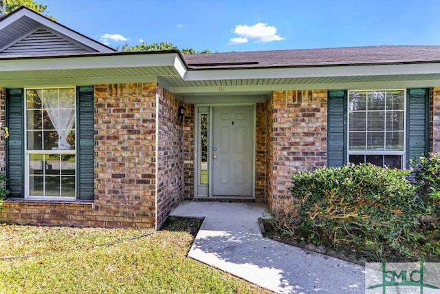 property entrance with brick siding