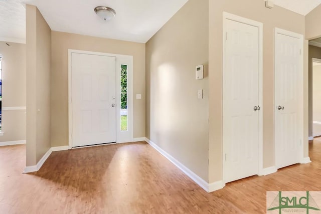 entryway with light wood-type flooring and baseboards