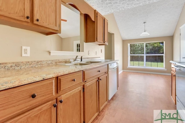 kitchen with dishwasher, baseboards, vaulted ceiling, and a sink