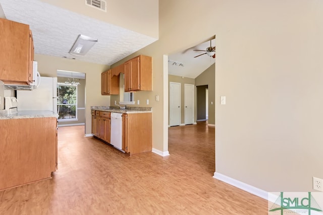 kitchen with light hardwood / wood-style floors, ceiling fan, a textured ceiling, white appliances, and lofted ceiling