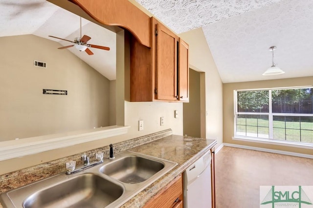 kitchen featuring lofted ceiling, dishwasher, visible vents, and a sink