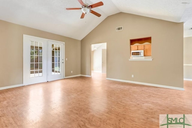 spare room with light wood-type flooring, baseboards, visible vents, and a ceiling fan