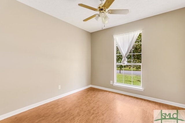 empty room with a textured ceiling, hardwood / wood-style flooring, and ceiling fan