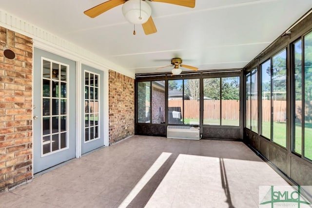 unfurnished sunroom featuring ceiling fan