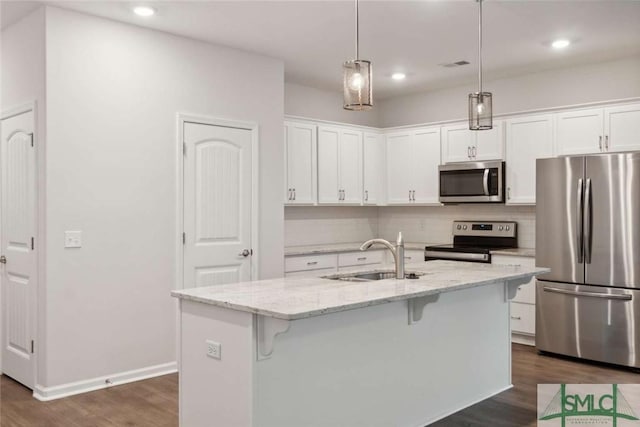 24 Pomona Cir, Savannah, GA 31419 - kitchen with appliances with stainless steel finishes, dark wood-style floors, a kitchen breakfast bar, white cabinets, and recessed lighting