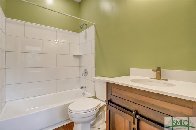 full bathroom featuring toilet, vanity, hardwood / wood-style flooring, and tiled shower / bath combo