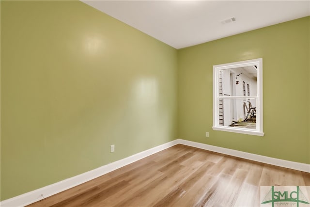 unfurnished room with light wood-type flooring