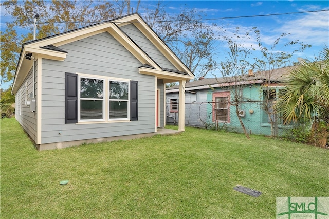 back of house with a yard