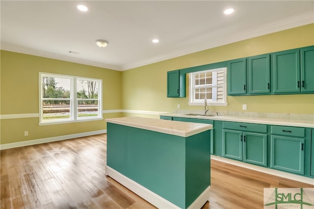 kitchen featuring a center island, sink, and green cabinetry