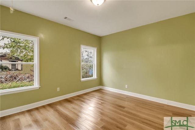 empty room featuring light hardwood / wood-style flooring and a healthy amount of sunlight