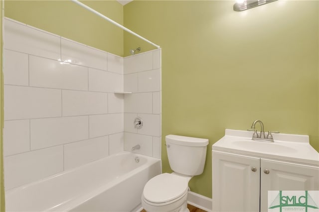 full bathroom featuring vanity, tiled shower / bath combo, and toilet