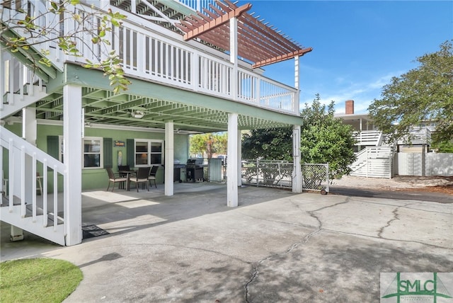 view of patio / terrace with a pergola, area for grilling, and a wooden deck